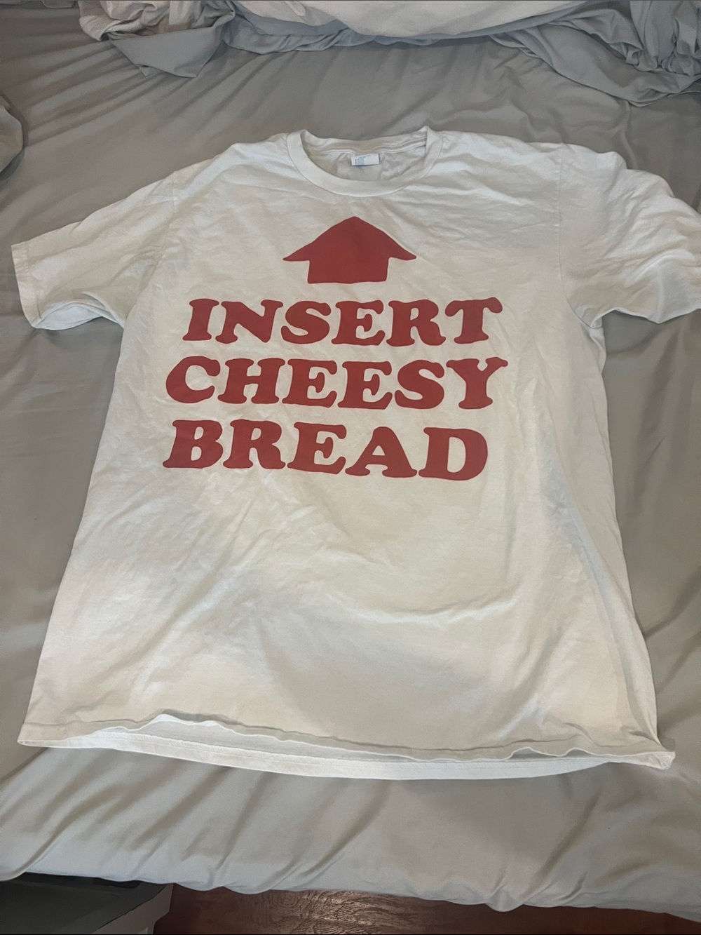 White Graphic Tee with Red "Insert Cheesy Bread" Print